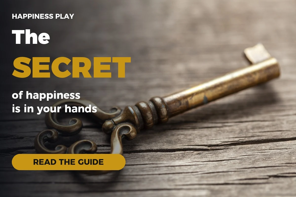 Old brass key on a wooden table with the title The secret of happiness is in your hands